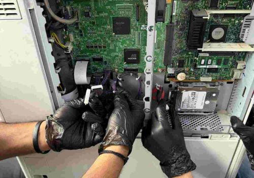 printer services, repair technicians are repairing a mother board of copier machine